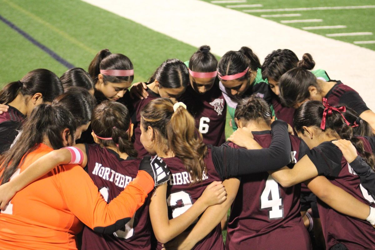 Ladies Soccer team huddles together after their game against Stratford High School.