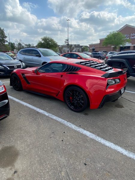 A beautiful red Corvette parked outside in the Spring Branch area. 