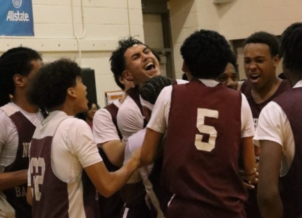 The boys basketball team celebrates after Terrell Woodward